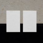 View from above, two blank outdoor business card mockups laying on the concrete.