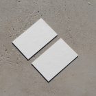 View from above, two blank outdoor business card mockups laying on the concrete.