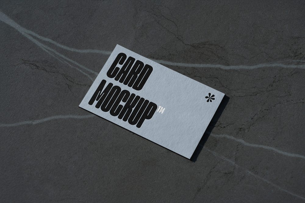 View from above, single outdoor business card mockup with blue and black colors and a strong design, laying lies on the navy gray marble color background.