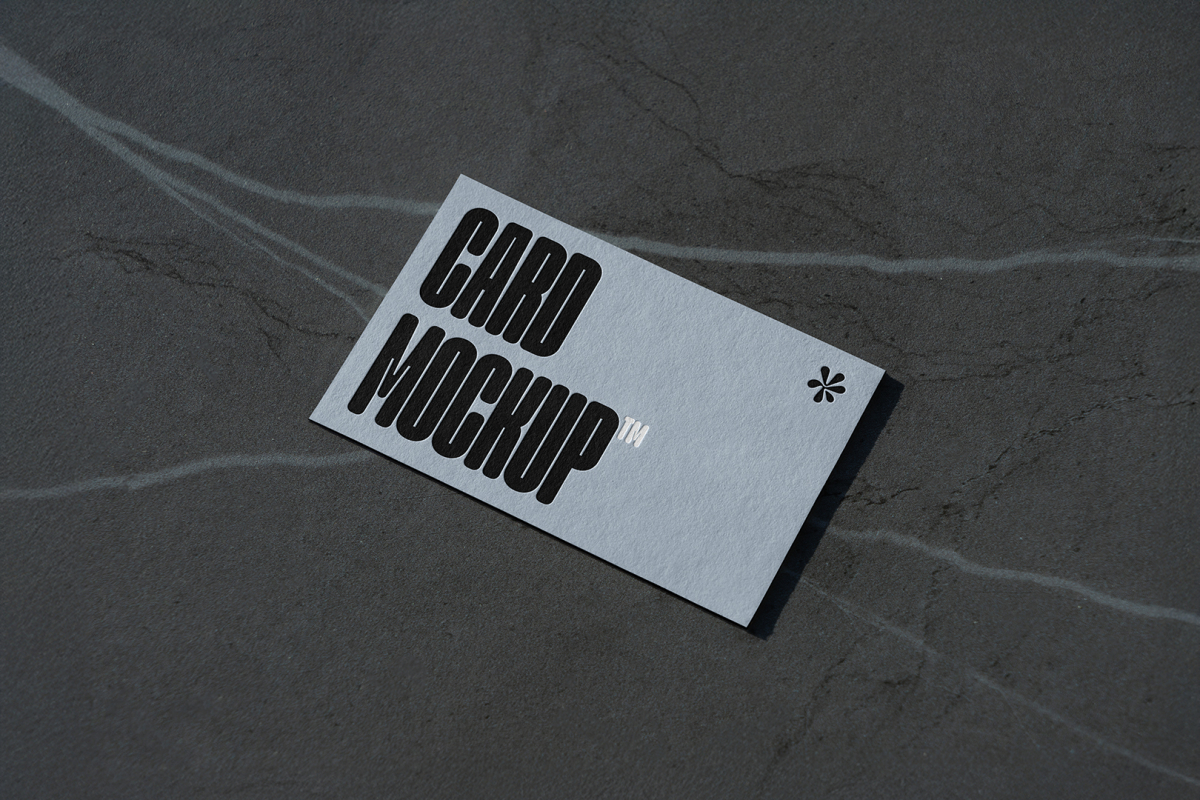 View from above, single outdoor business card mockup with blue and black colors and a strong design, laying lies on the navy gray marble color background.