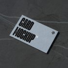 View from above, single outdoor business card mockup with blue and black colors and a strong design, laying lies on the navy gray marble color background.