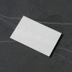 View from above, a single blank outdoor business card mockup laying lies on the navy gray marble color background.