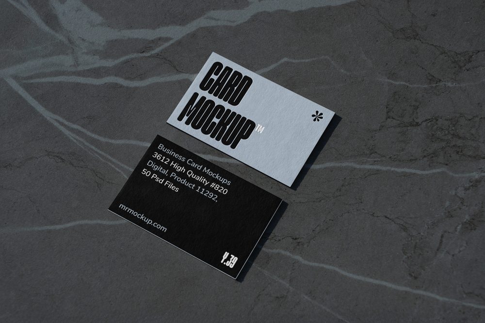 View from above, two outdoor business card mockups with blue and black colors and a strong design, laying lies on the navy gray marble color background.