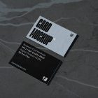 View from above, two outdoor business card mockups with blue and black colors and a strong design, laying lies on the navy gray marble color background.