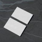 View from above, two blank outdoor business card mockups laying lies on the navy gray marble color background.