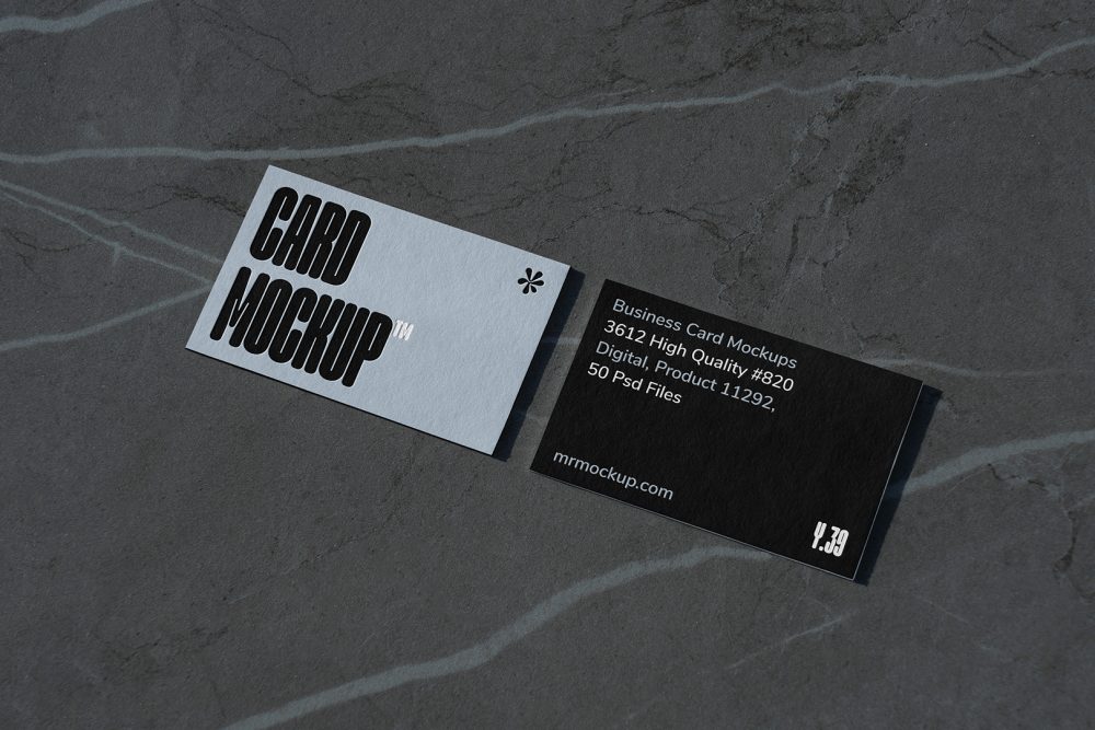 View from above, two outdoor business card mockups with blue and black colors and a strong design, laying lies on the navy gray marble color background.