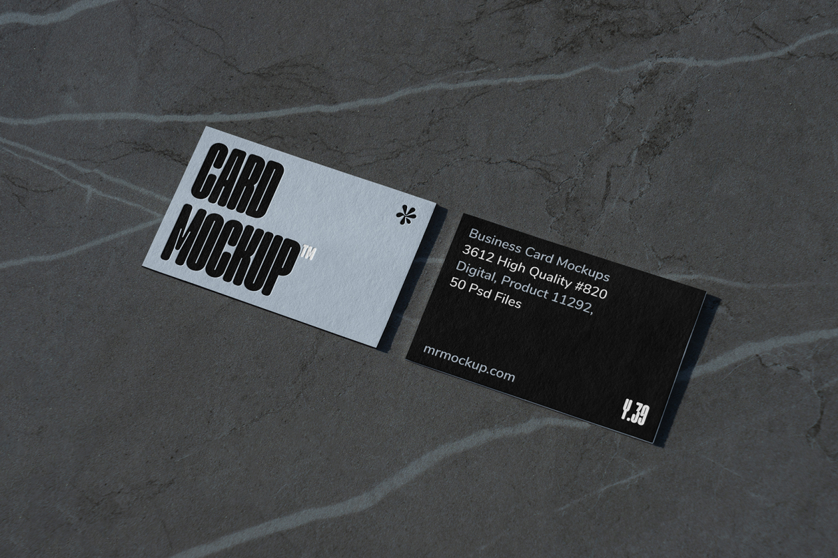 View from above, two outdoor business card mockups with blue and black colors and a strong design, laying lies on the navy gray marble color background.