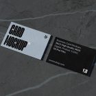 View from above, two outdoor business card mockups with blue and black colors and a strong design, laying lies on the navy gray marble color background.