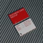 View from above, two outdoor business card mockups with red and white colors, geometric typography design, laying on roof tiles.