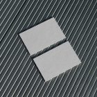 View from above, two blank outdoor business card mockups laying on roof tiles.