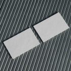 View from above, two blank outdoor business card mockups laying on roof tiles.