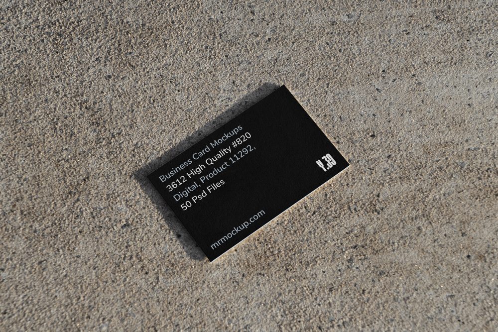 View from above, single outdoor business card mockup with blue and black colors, strong typography design, laying on the sand background.