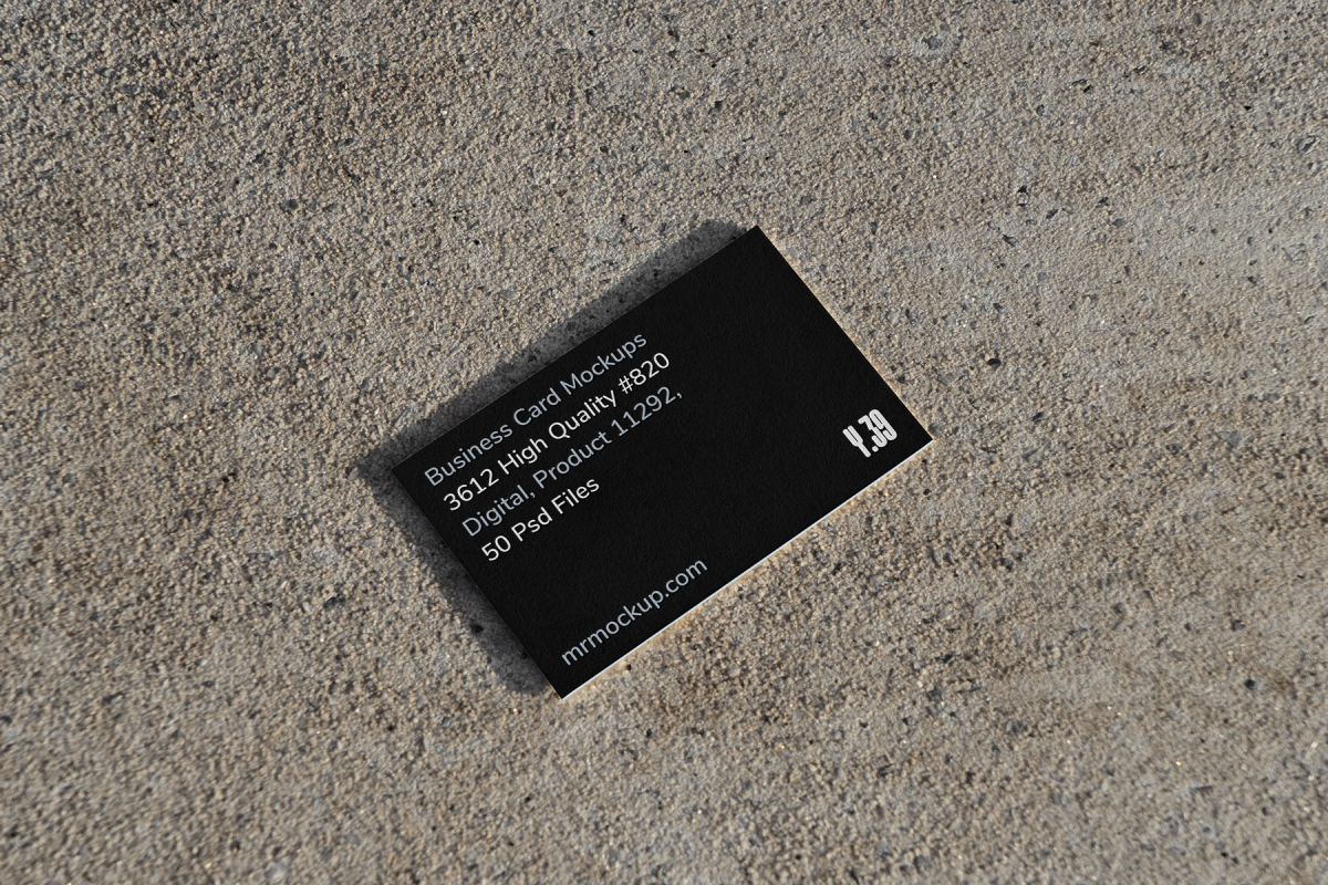 View from above, single outdoor business card mockup with blue and black colors, strong typography design, laying on the sand background.