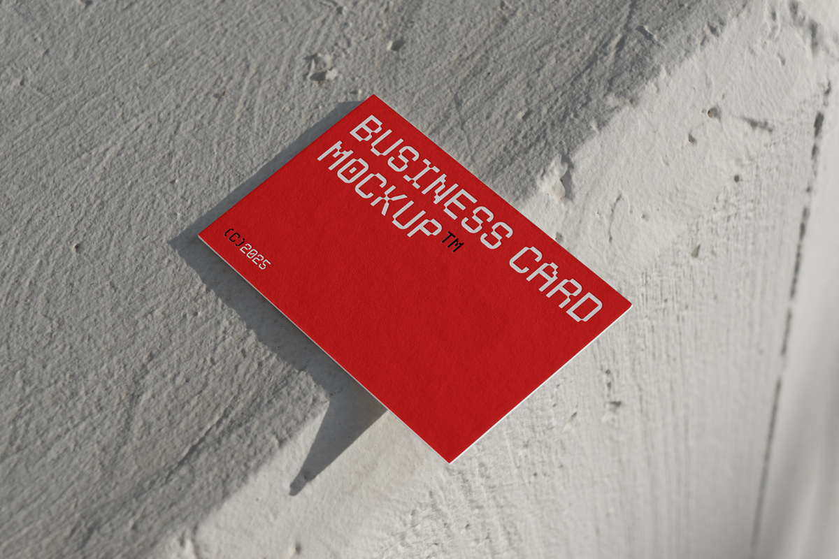 View from above, outdoor business card mockup with red and white colors, geometric typography design laying on the white color concrete.