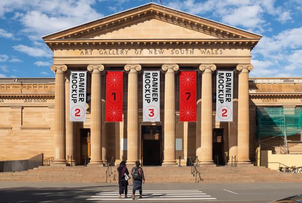 Hanging vertical banner mockups on the front facade of art gallery building.