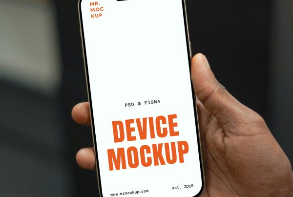 Hand Holding iPhone Pro Mockup with a blurred office view in the background.