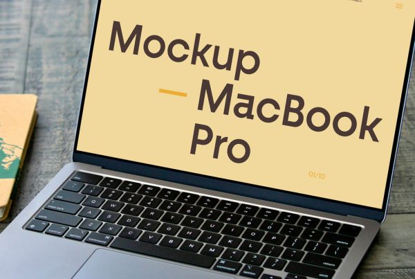 Front view, open silver MacBook Pro Mockup laying on the wooden table.