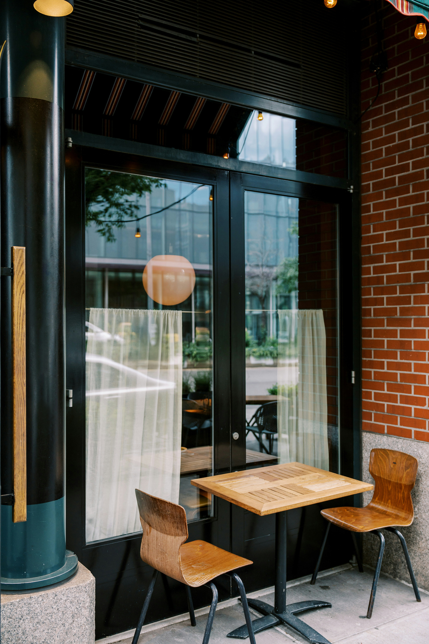 Front view, restaurant storefront mockup with vertical tinted windows.