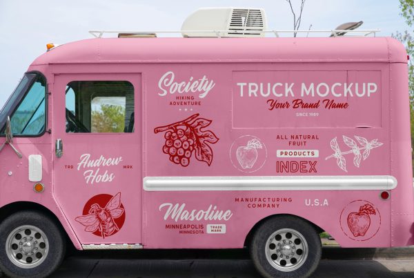 Front view, vintage food truck mockup with a lot of colorful graphics design on the bodywork standing in the parking.