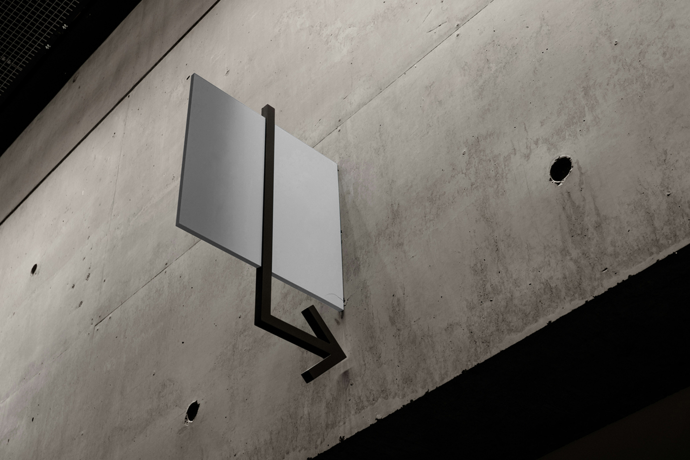 White wayfinding Vertical Sign Mockup attached to the concrete wall.