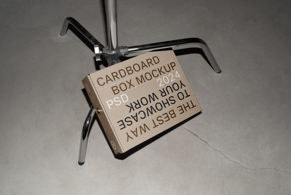 View from above of a craft box mockup with white, brown and black strong typography design based on a metal tripod.