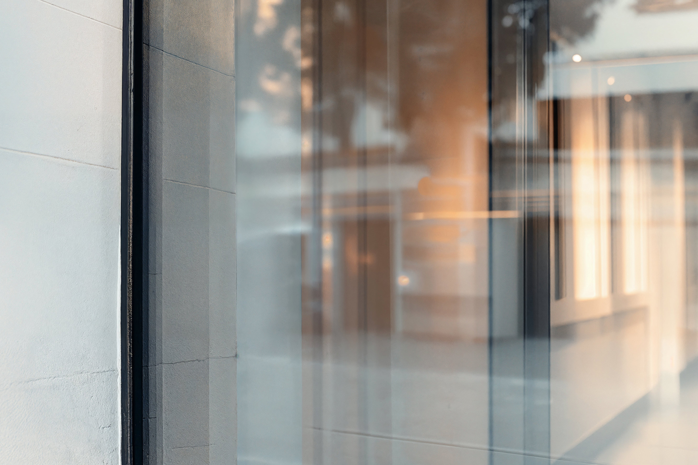 Front view, at an angle of 45 degrees, clean glass Storefront Mockup.