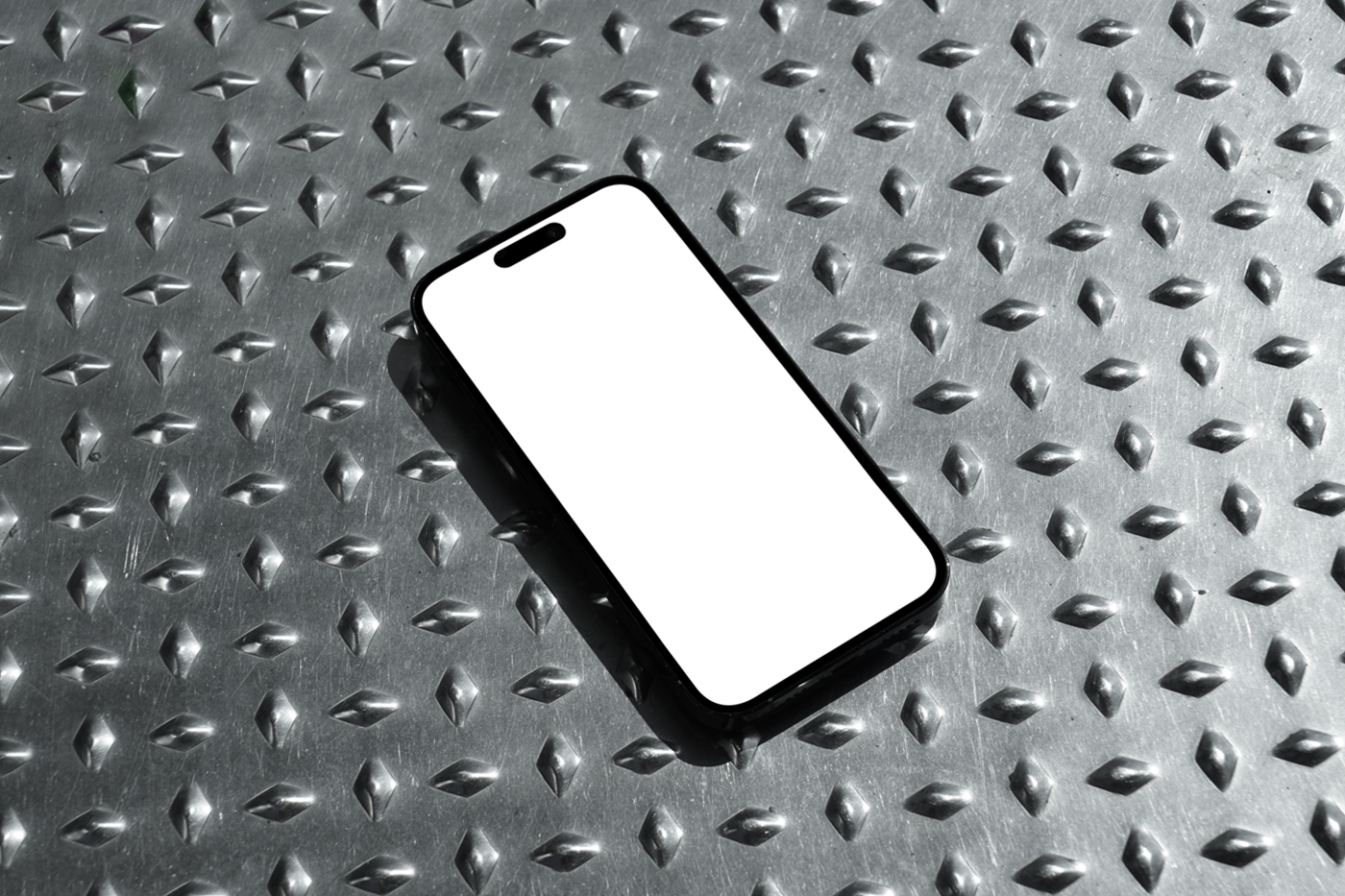 View from above, iPhone 16 Pro Mockup with white screen laying on the metal floor.