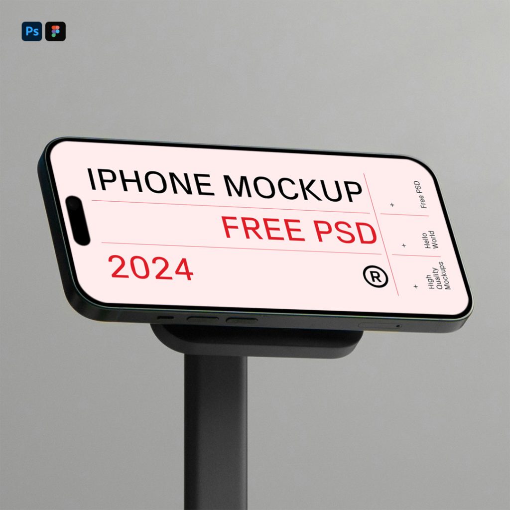 Front view, plugged into the docking station, iPhone 16 Pro Mockup standing on the black desk with a visible dark gray wall behind.