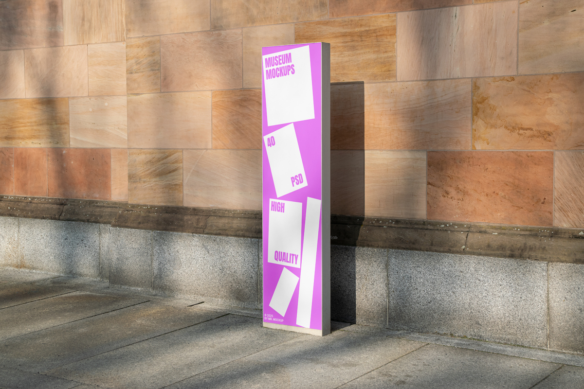 Front view, Stand Mockup with white and pink design standing before a big wall. Scene from our Museum Mockups product.