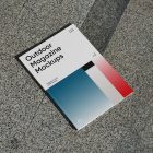 View from above, a single outdoor magazine mockup with three gradient shades and strong typography design lying on the marble background.