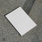 View from above, a single white outdoor magazine mockup lying on the marble background.