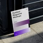 Front View, Outdoor Magazine Mockup with three gradient shades and strong typography design resists on metal fence in black color.