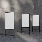 Front view, Three White Poster Mockups and metal frames in black color. Standing in the corner before the concrete wall. Scene from our Museum Mockups product.