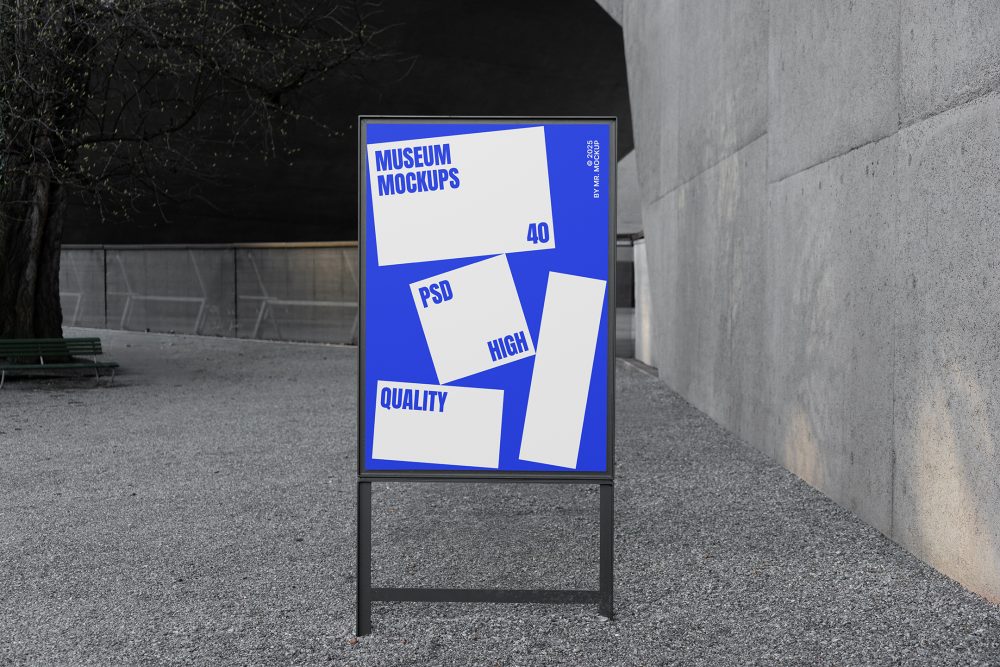 Front view, Poster Mockup with black metal frame and white and blue design. Standing on the patio. Scene from our Museum Mockups product.