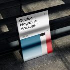 Front View, Outdoor Magazine Mockup with three gradient shades and strong typography design resists on metal fence in black color.