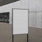 Front view, White Poster Mockup holding on a black metal pole. Standing against the background of a gray concrete wall. Scene from our Museum Mockups product.