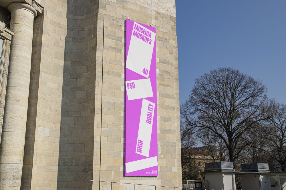 Front view, Vertical Billboard Mockup with white and pink design attached to the old building against the sky. Scene from our Museum Mockups product.