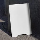 Front view, White Stand Mockup standing against the wall next to the entrance. Scene from our Museum Mockups product.