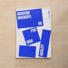 Front view, Hanging Banner Mockup with white and blue design in front of a beige brick colored wall. Scene from our Museum Mockups product.