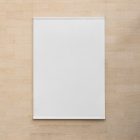Front view, Hanging White Banner Mockup in front of a beige brick colored wall. Scene from our Museum Mockups product.