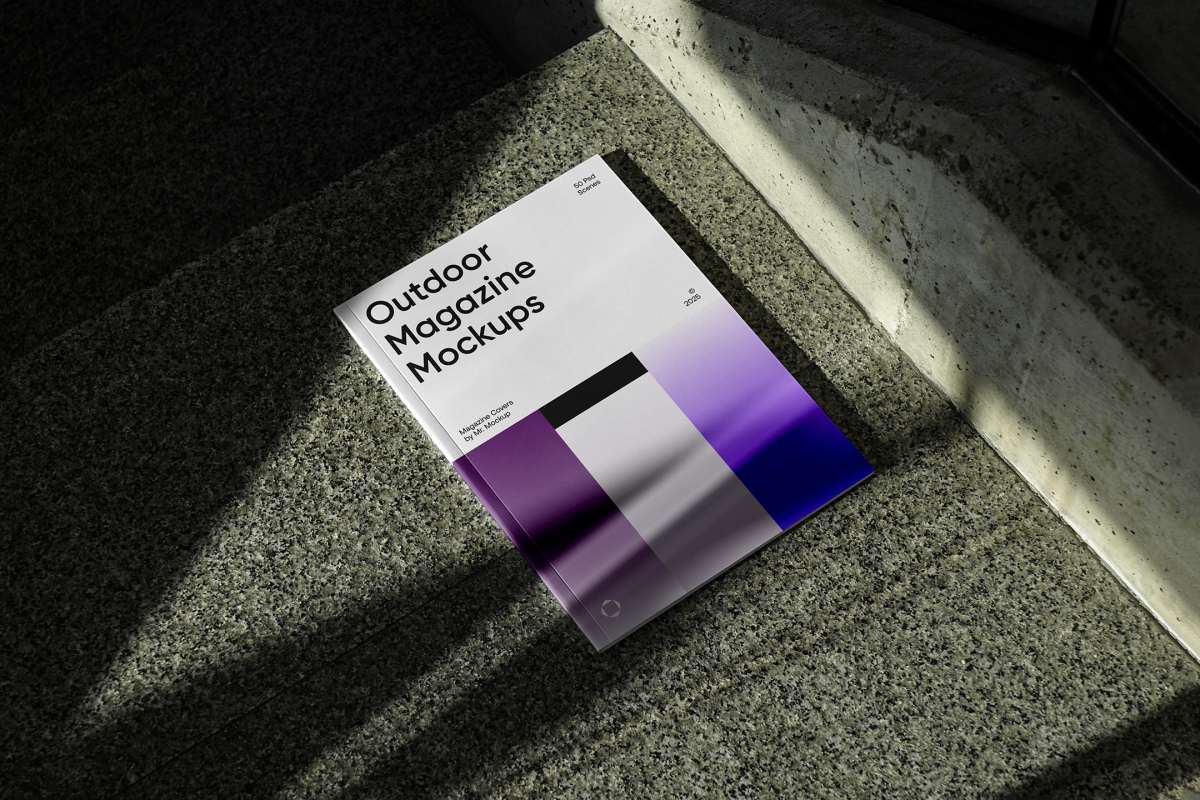 View from above of an Outdoor Magazine Mockup with three gradient shades and strong typography design lying on marble.