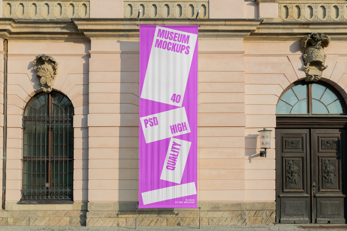 Front view, Hanging Vertical Banner Mockup with white and pink design attached to the silver pole in front of the old building elevation. Scene from our Museum Mockups product.