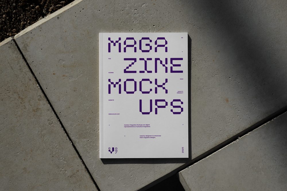 View from above of an Outdoor Magazine Mockup with strong purple typography design lying on concrete slabs.
