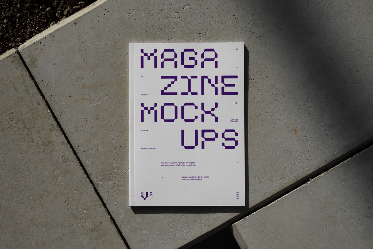 View from above of an Outdoor Magazine Mockup with strong purple typography design lying on concrete slabs.