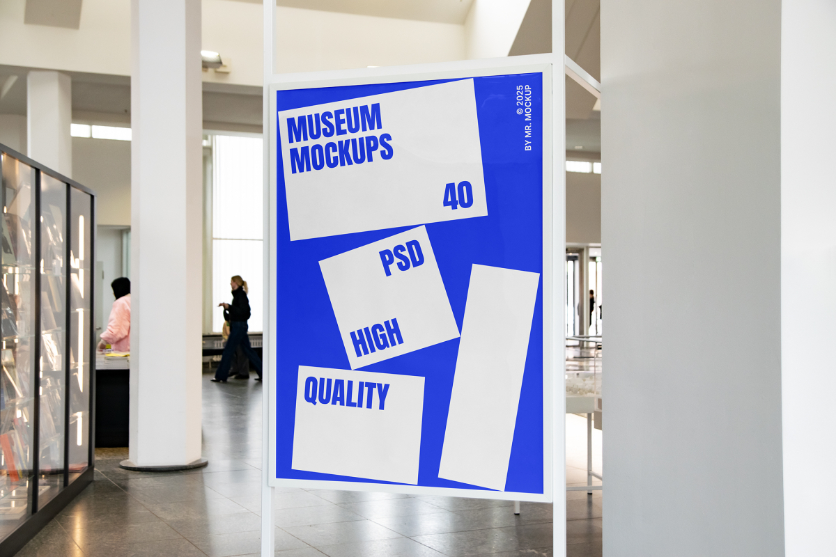 Front view, Poster Mockup with white and blue design and white metal frame standing inside the building. Scene from our Museum Mockups product.