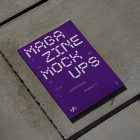 View from above of an Outdoor Magazine Mockup with strong purple typography design lying on concrete slabs.