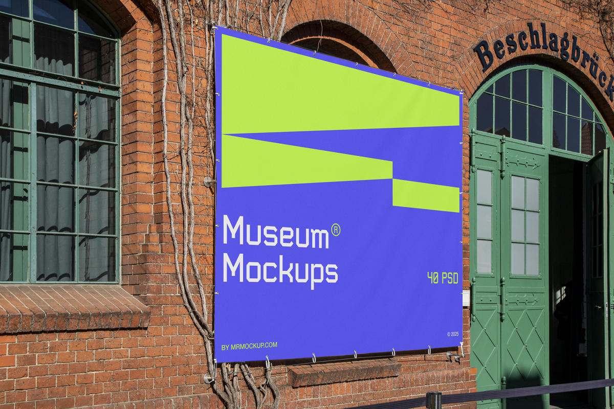 Front view, Rectangle Banner Mockup with white, purple, and neon green geometric design attached to the classic brick colored wall on an old building elevation. Scene from our Museum Mockups product.
