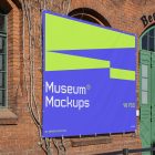 Front view, Rectangle Banner Mockup with white, purple, and neon green geometric design attached to the classic brick colored wall on an old building elevation. Scene from our Museum Mockups product.
