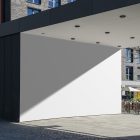 Front view, White Wall Mockup in front of the buildings. Scene from our Museum Mockups product.