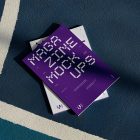 View from above of two outdoor magazine mockups with strong purple typography designs lying on a basketball court.